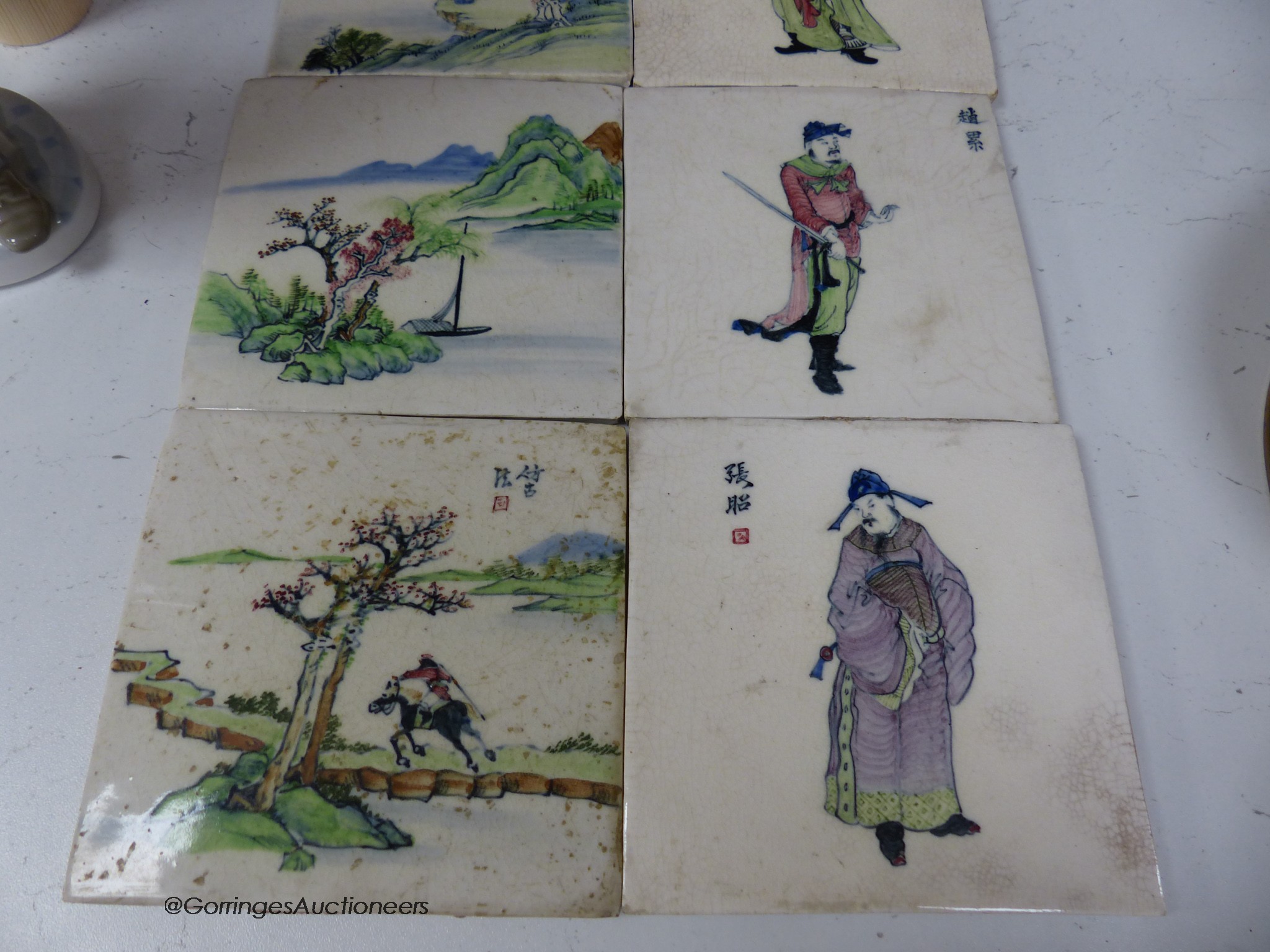 Four Chinese landscape tiles and four Chinese figurative tiles, 13cm square